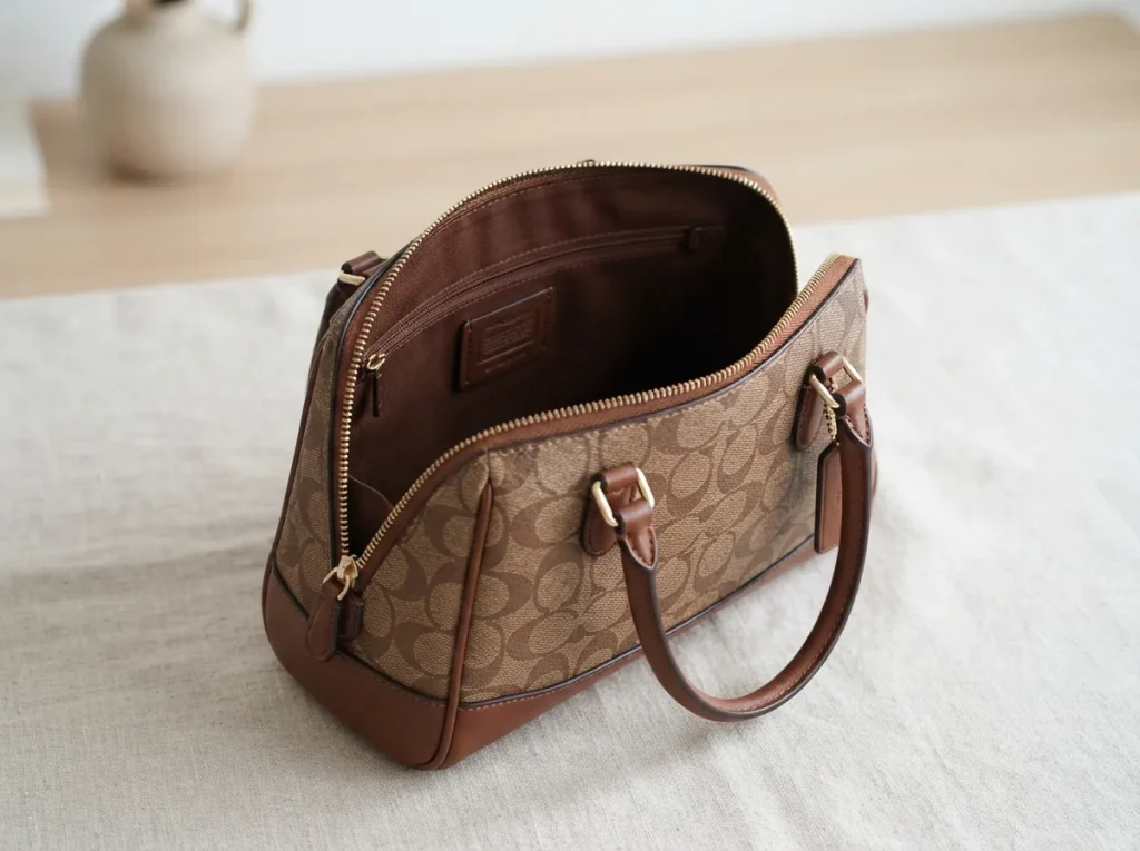 Coach Plaza Bag 18 displayed open to show interior and exterior design features.